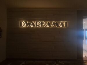 Premium Sign Board Dubai – Backlit 3D acrylic letter sign installed for DWARKAMAI with warm LED illumination